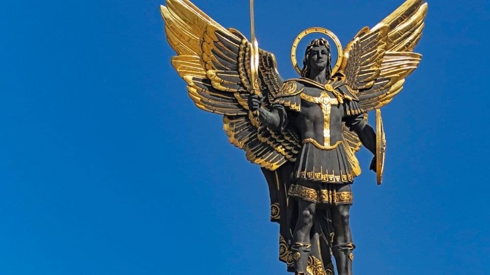 archangel with sword up and blue sky
